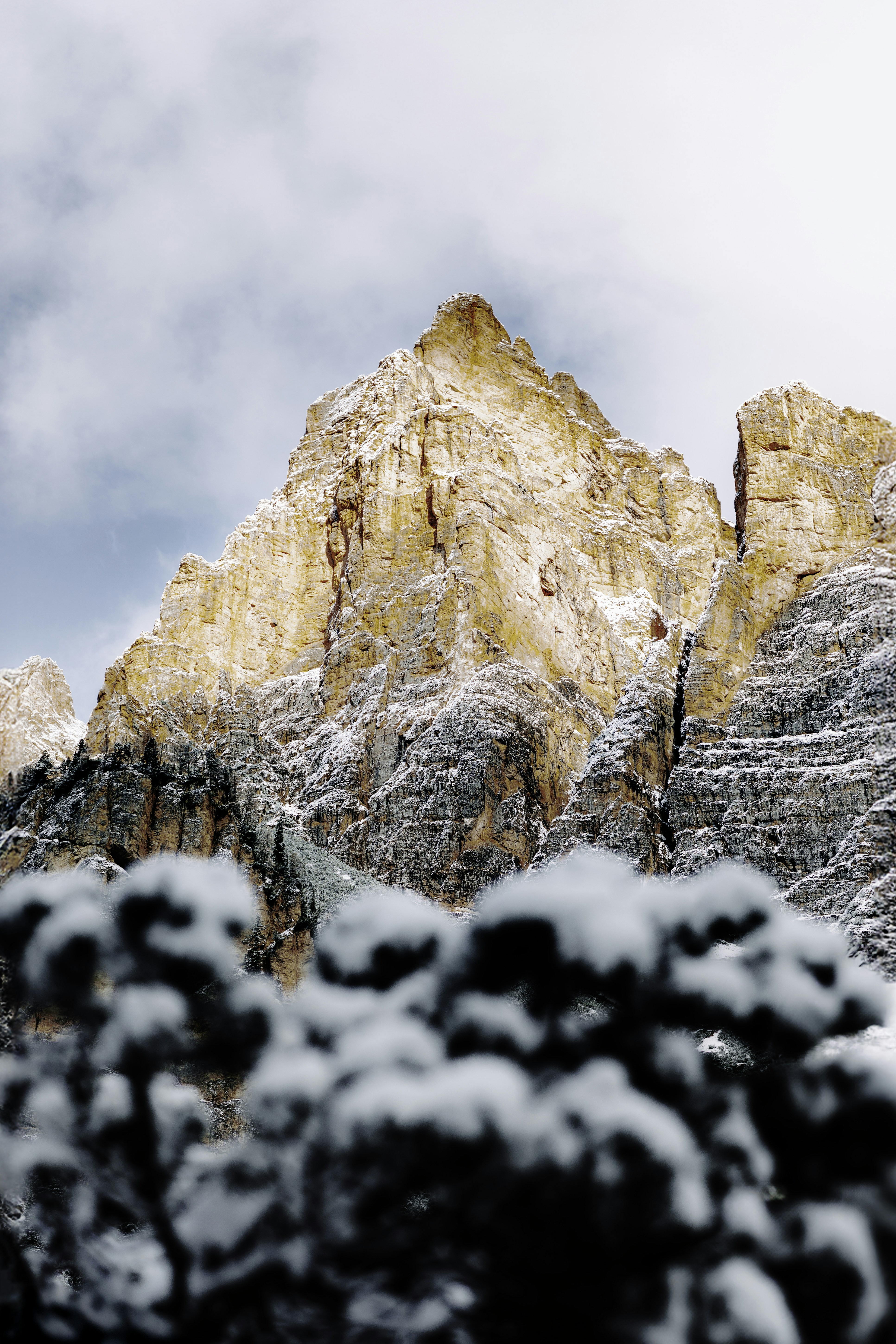 A mountain covered in snow with a sky background