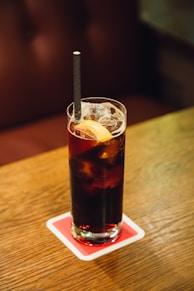 A glass of soda on a wooden table