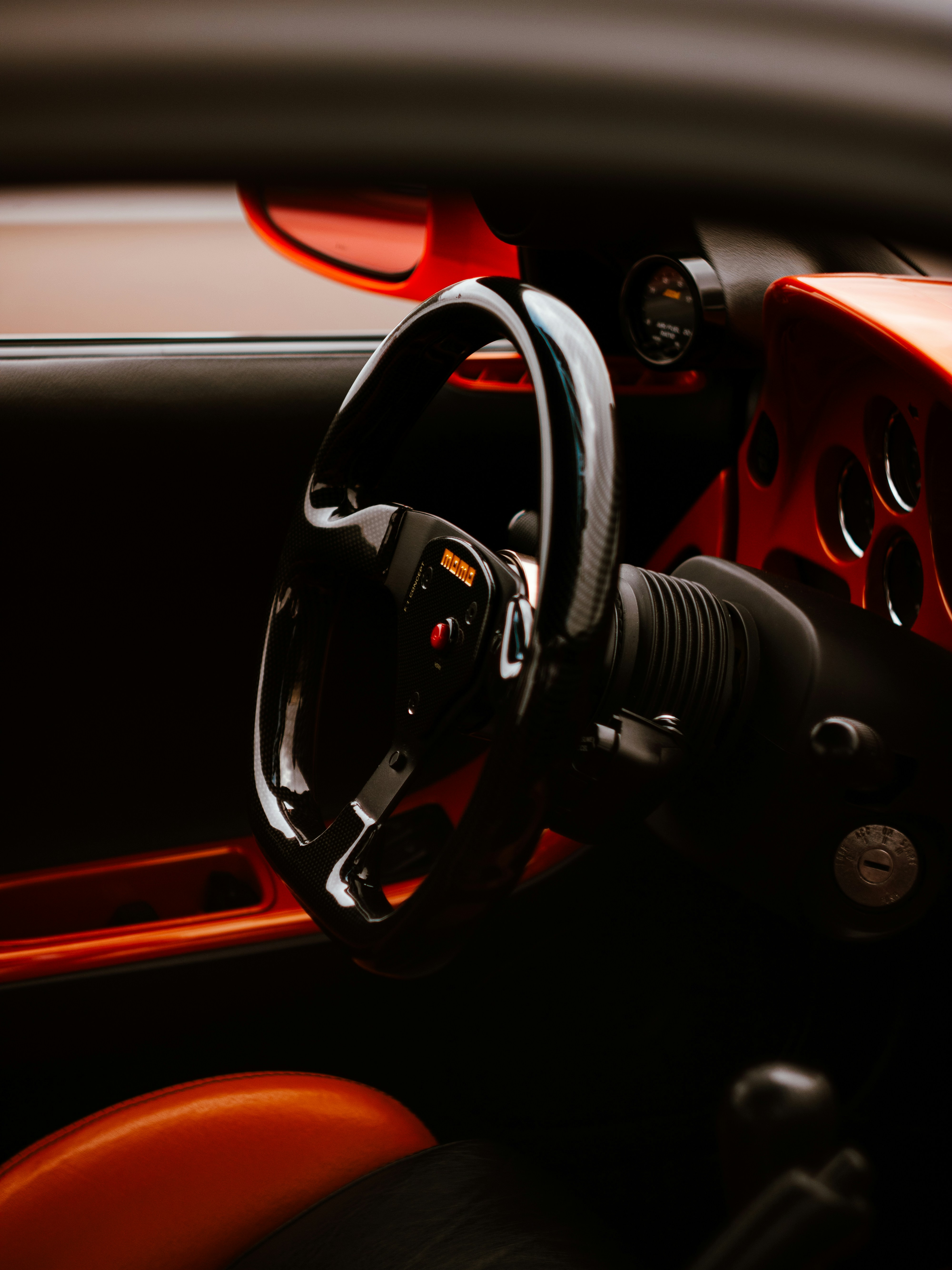 The interior of a car with a steering wheel and dashboard