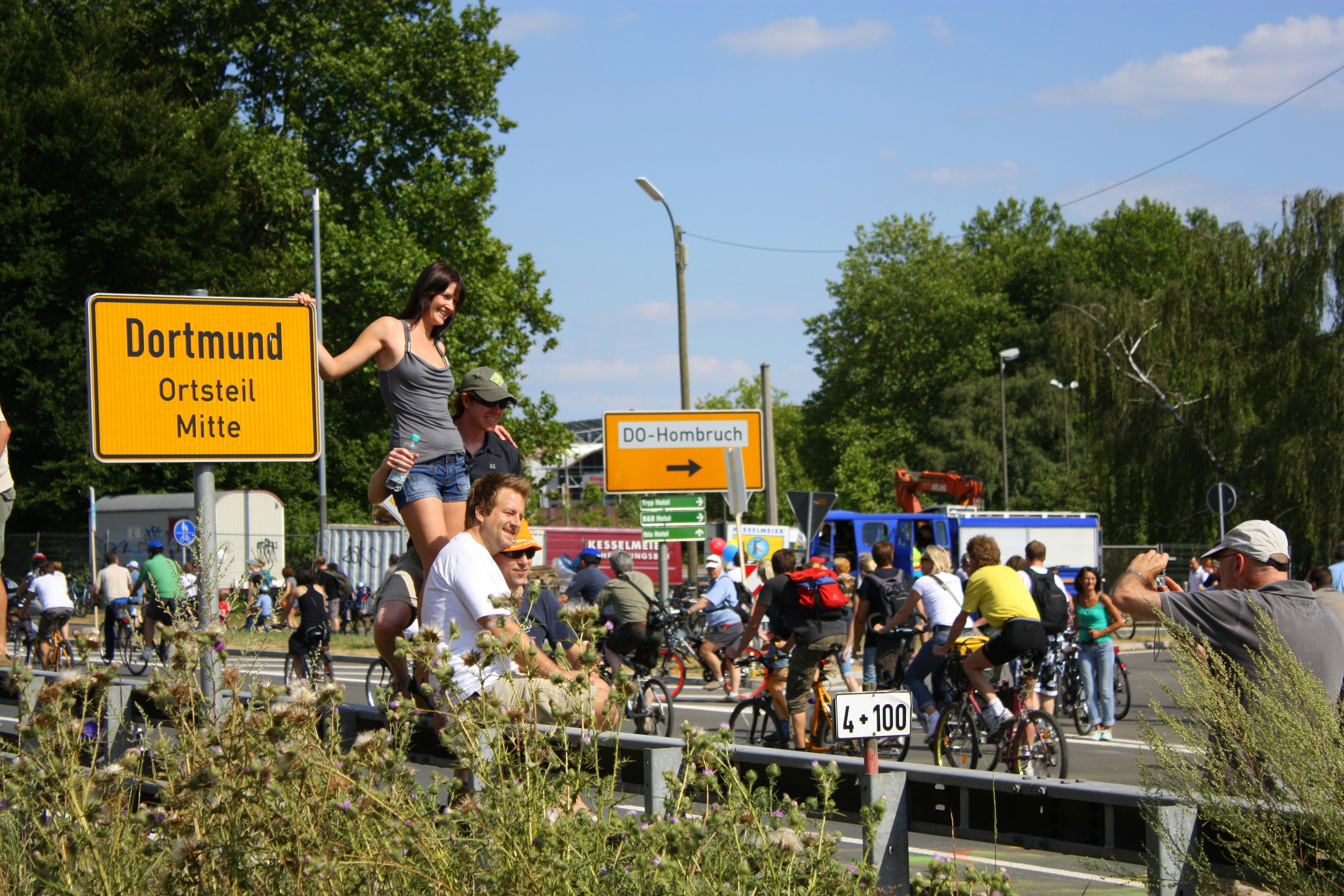 A group of people riding bikes down a street