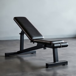 A black bench sitting on top of a gray floor