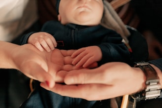 A woman holding a baby in her hands