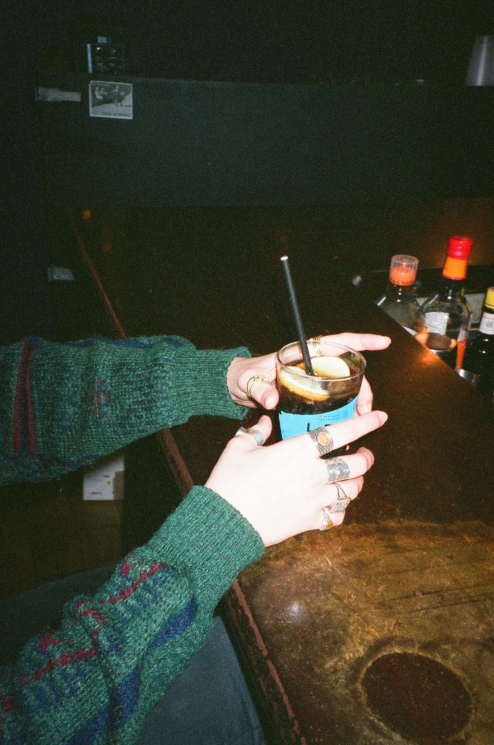 A person holding a drink in their hand