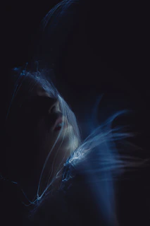 A blurry photo of a woman's face in the dark