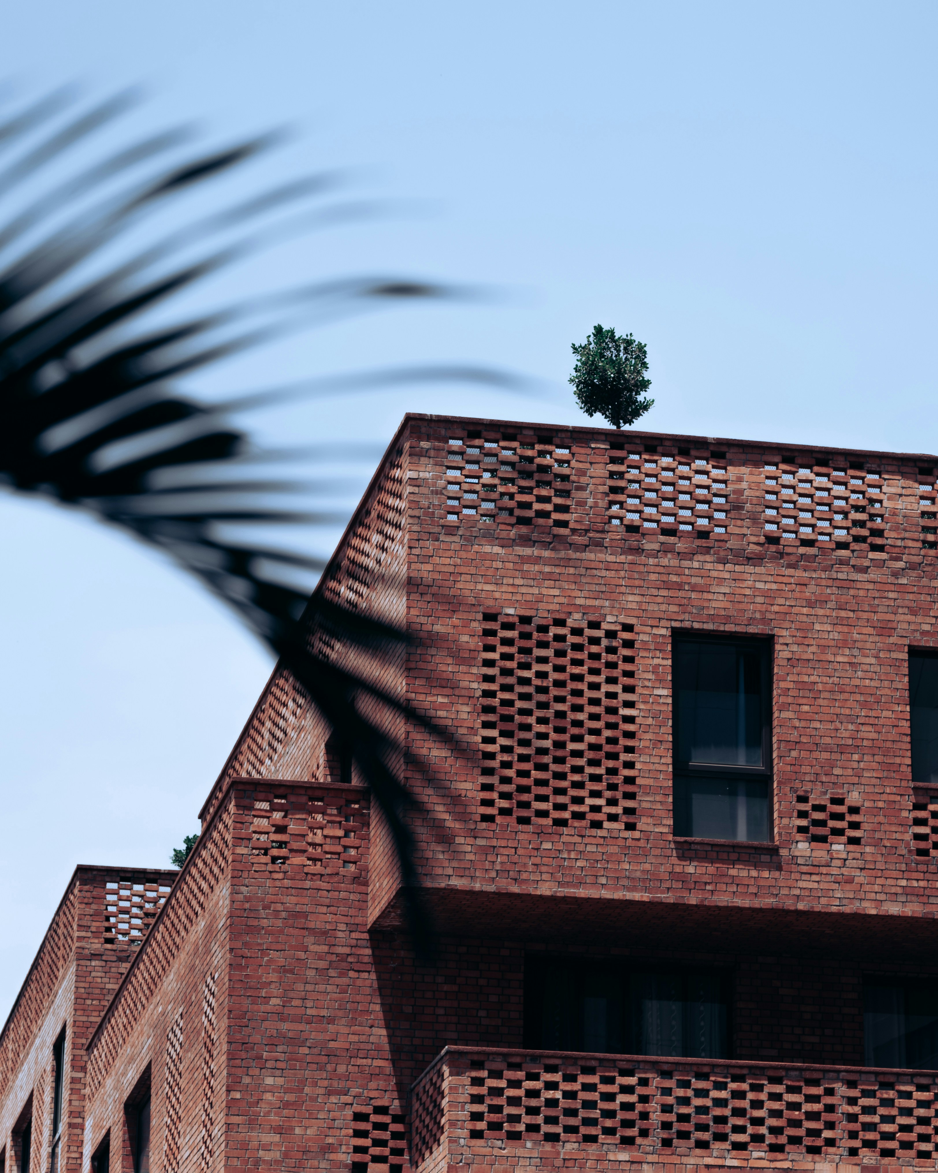 A tall brick building with a clock on the top of it