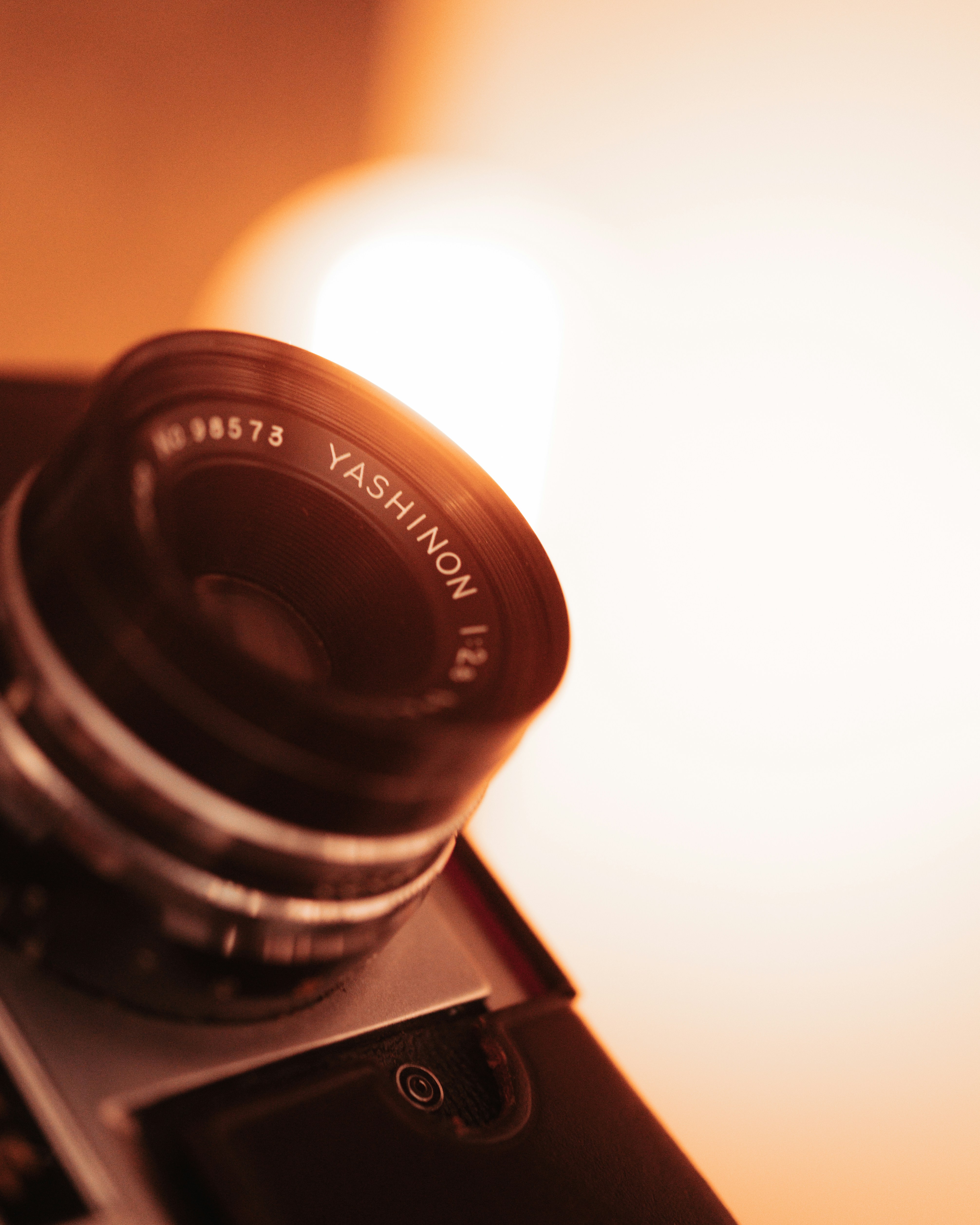 A camera sitting on top of a laptop computer
