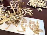 A wooden model of a mechanical device on a table