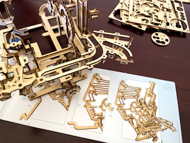 A wooden model of a mechanical device on a table
