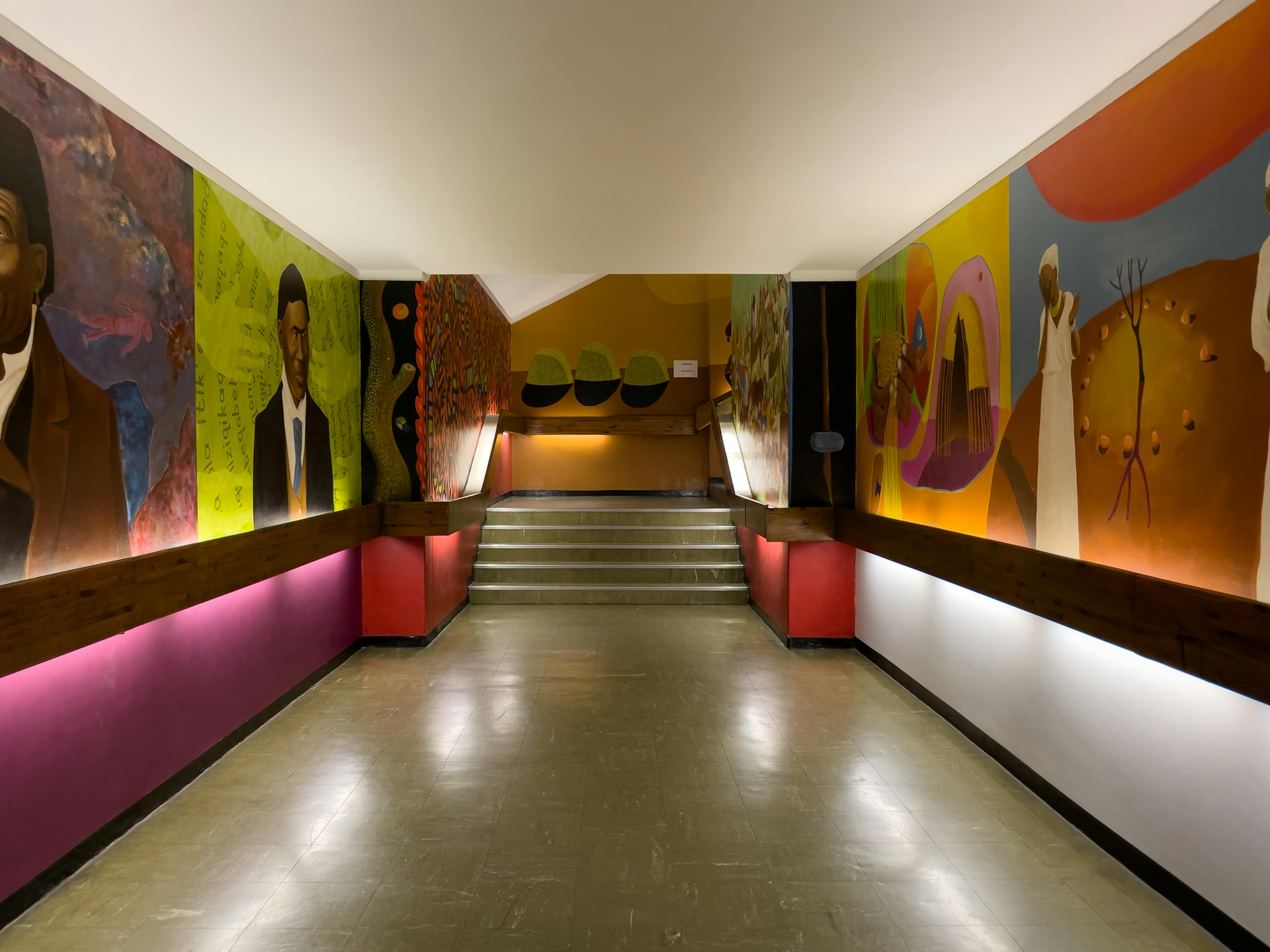 A long hallway with paintings on the walls