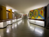 A long hallway with paintings on the walls