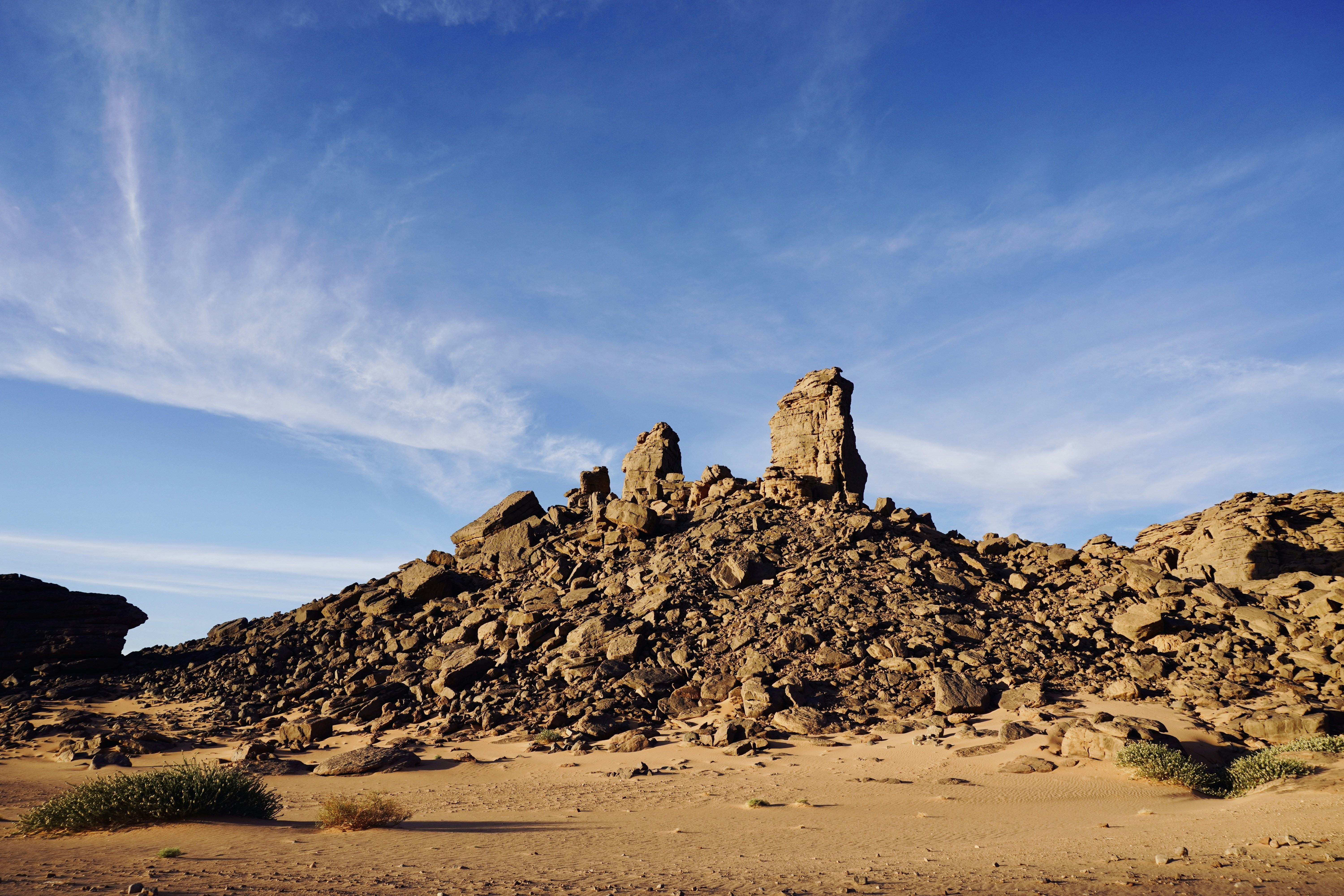 A large pile of dirt sitting in the middle of a desert