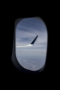 A view of the wing of an airplane through a window