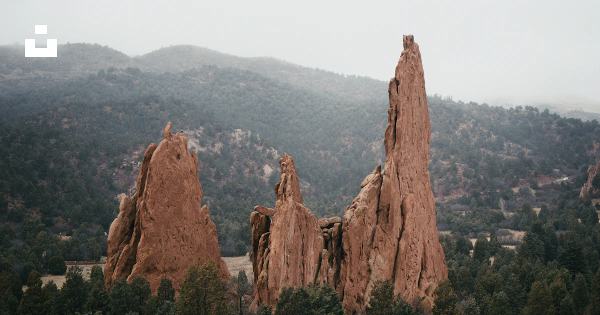 A large rock formation in the middle of a forest photo – Free Red rocks ...