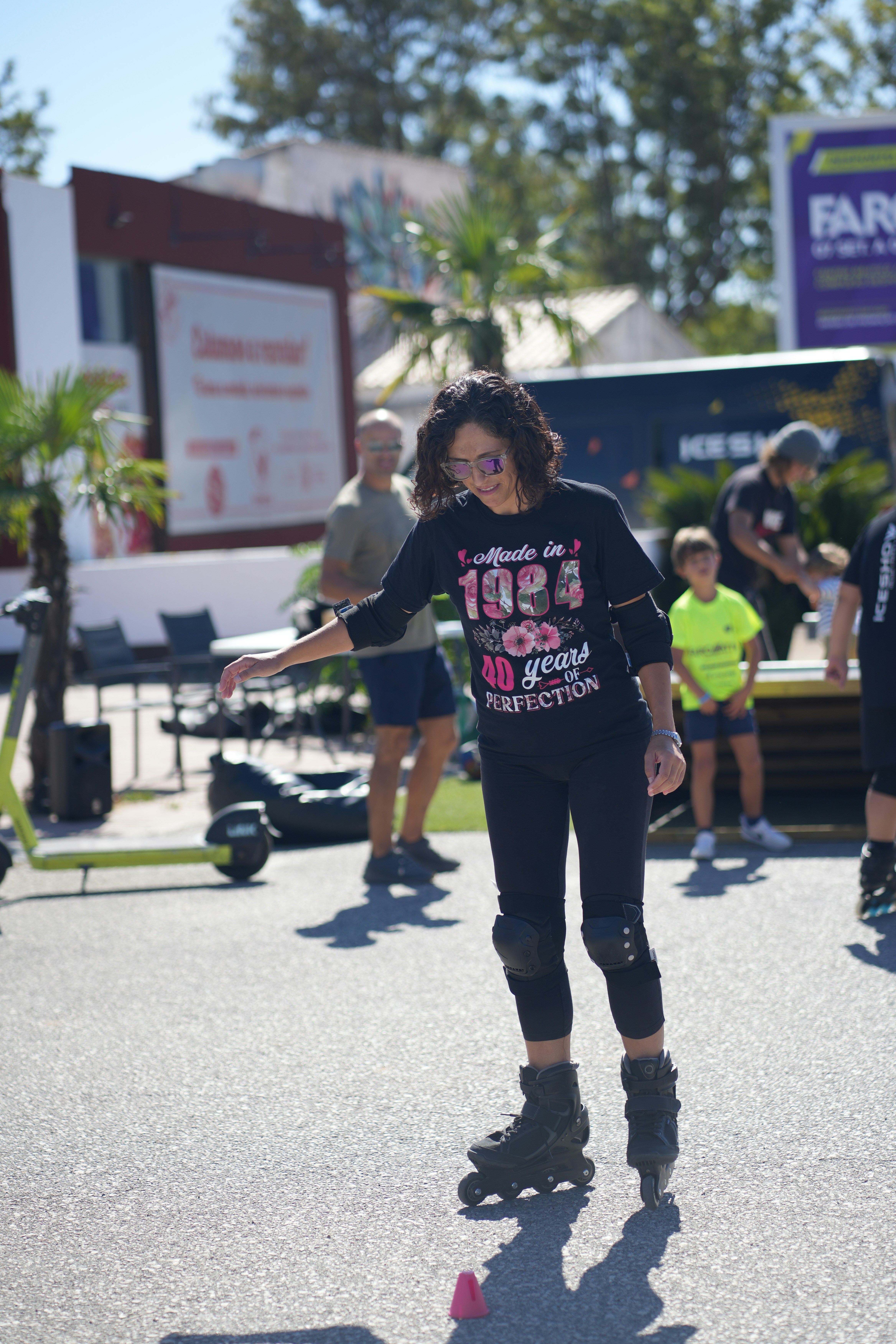 A group of people riding skateboards down a street