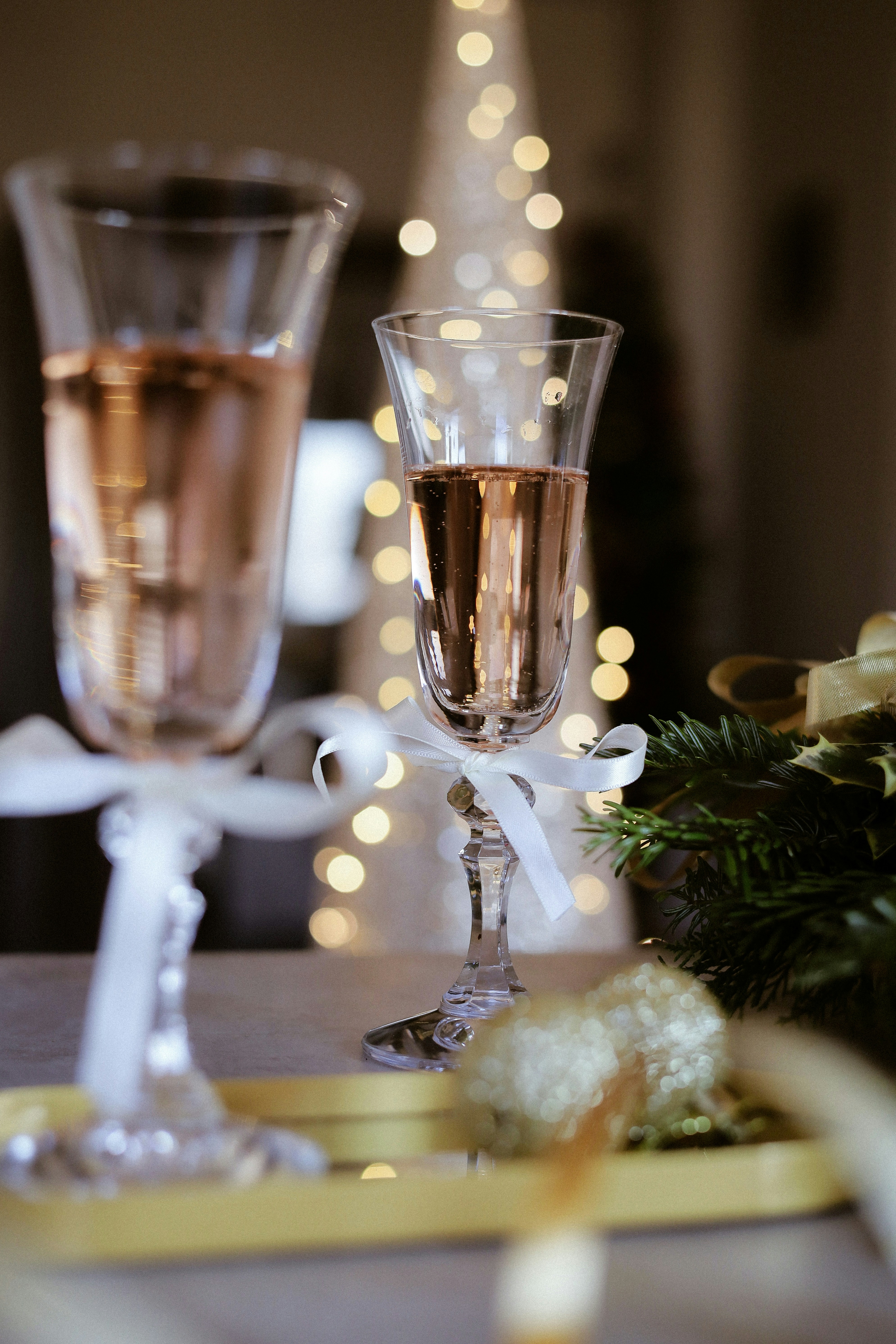 A glass of bubbly champagne with a festive garnish