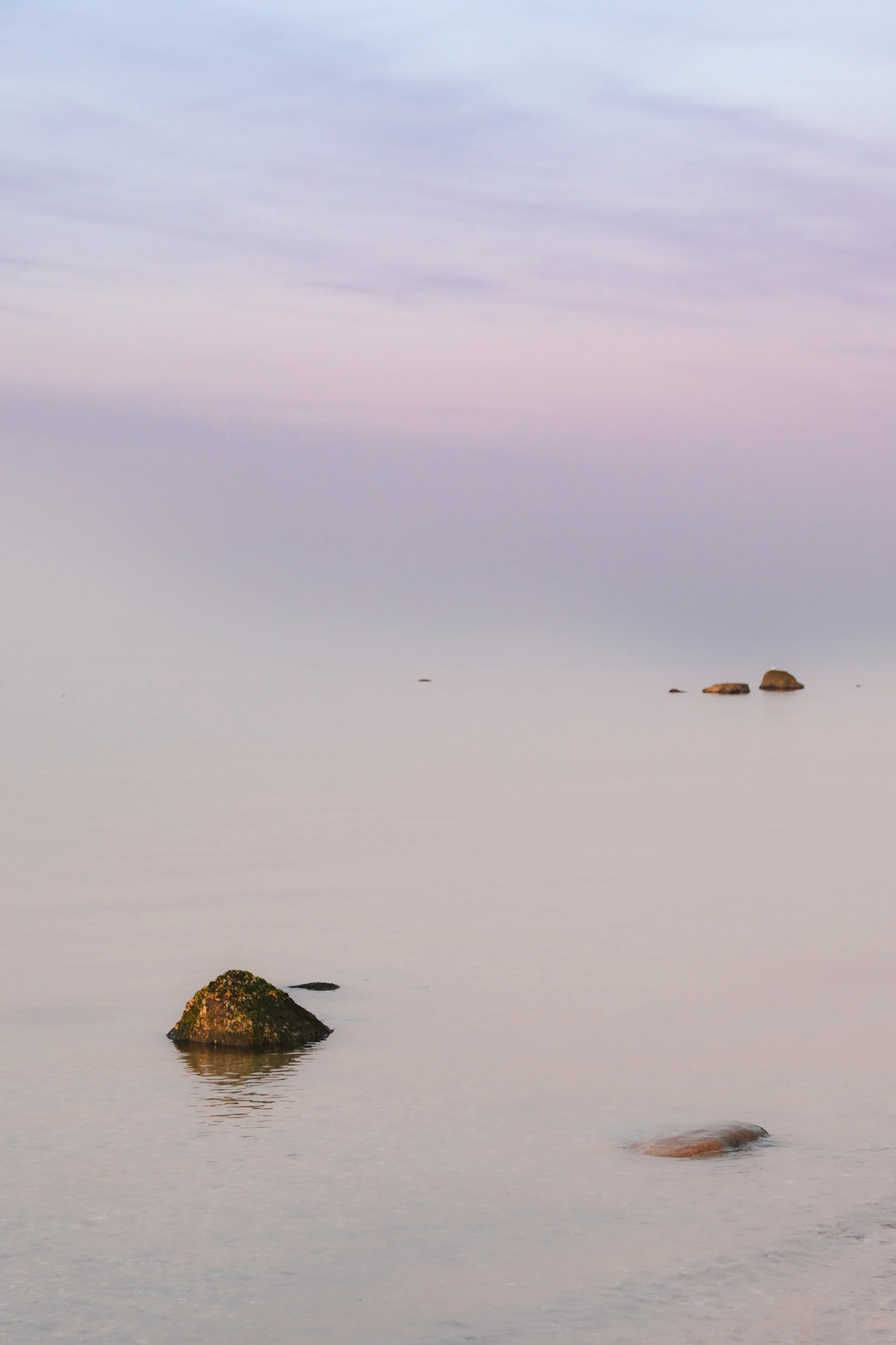 A body of water that has some rocks in it