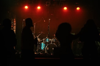 A group of people that are standing in front of a stage