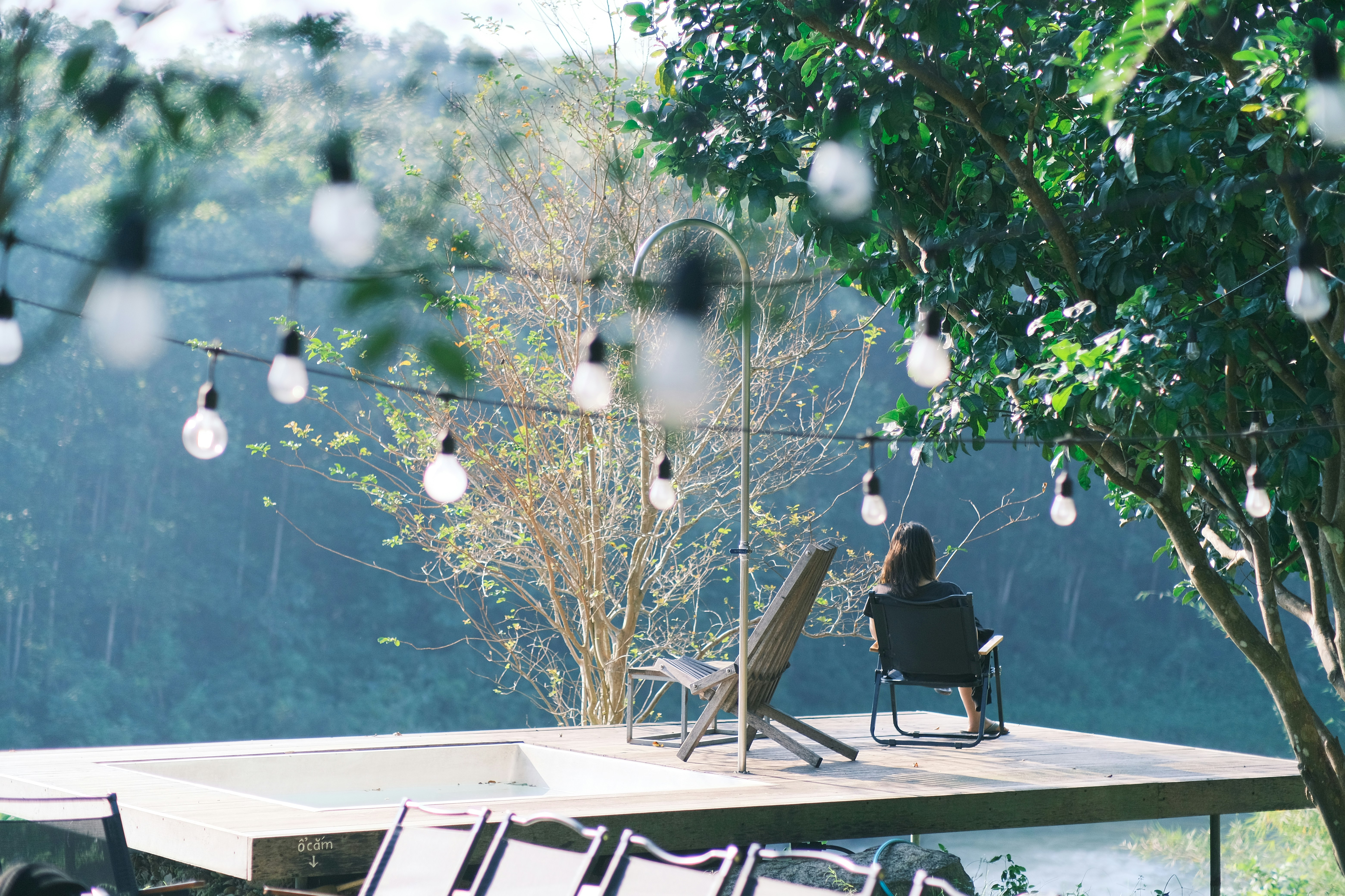 A person sitting in a chair on top of a deck