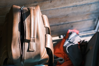 A suitcase sitting next to a pile of luggage