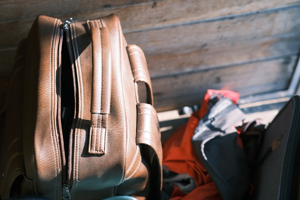 A suitcase sitting next to a pile of luggage