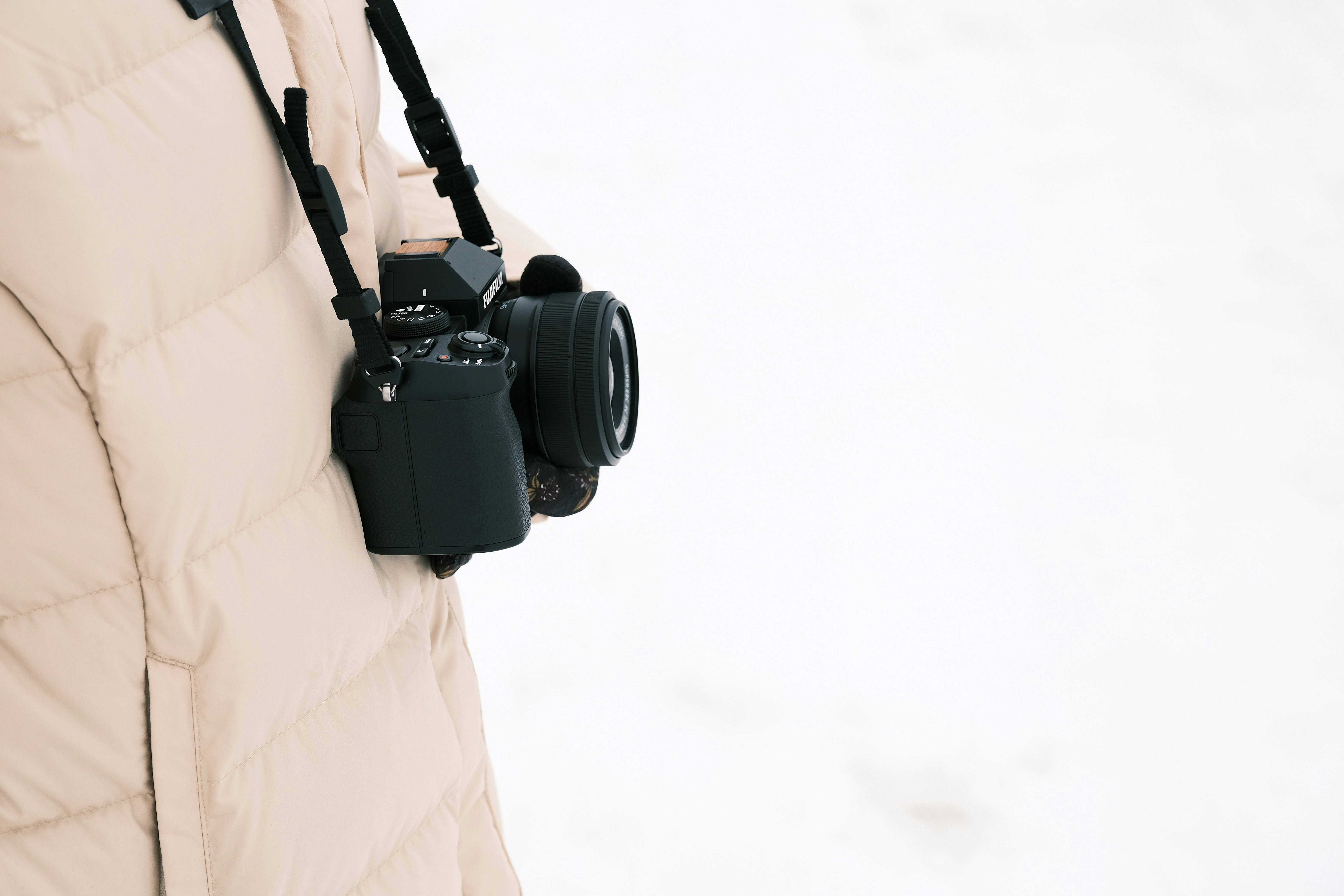 A woman holding a camera in her right hand