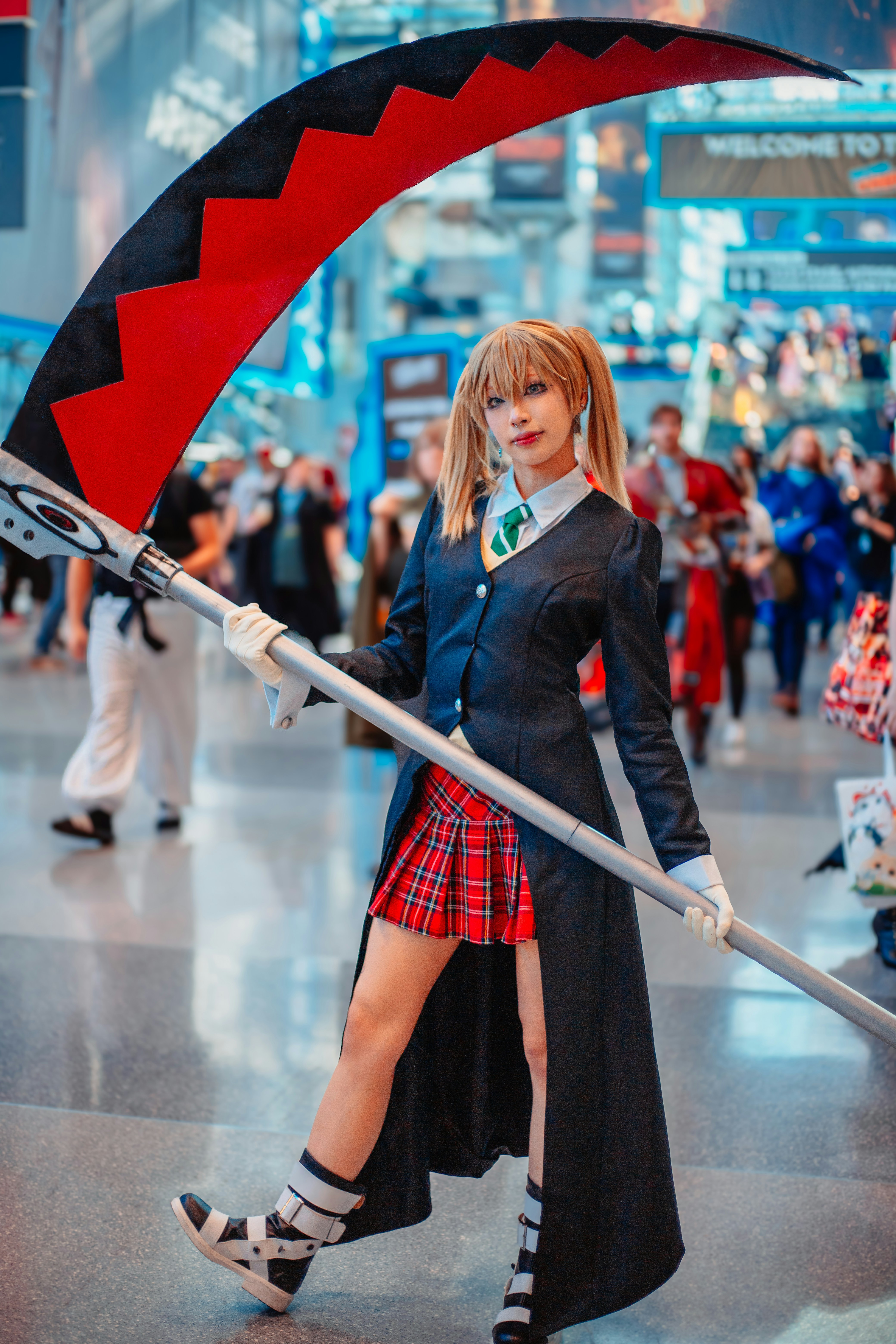 A woman in a school uniform holding a giant umbrella