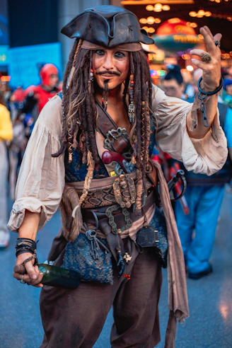 A man with dreadlocks and a pirate costume