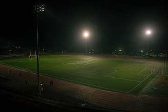 A soccer field is lit up at night
