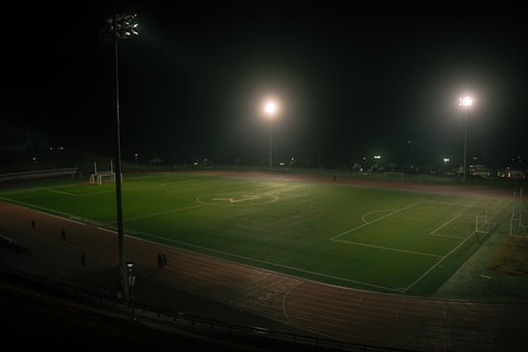 A soccer field is lit up at night