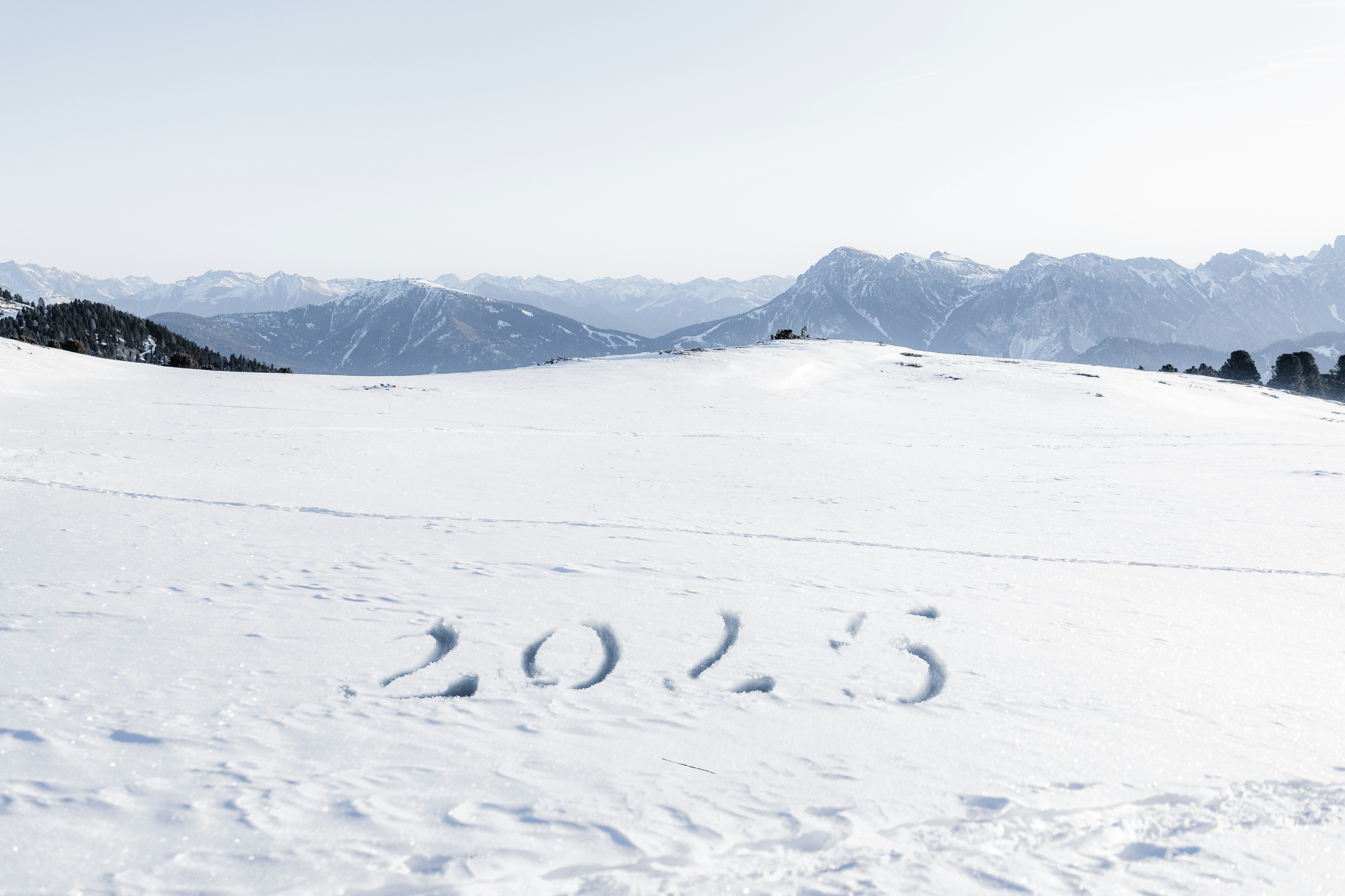 A person riding skis on top of a snow covered slope