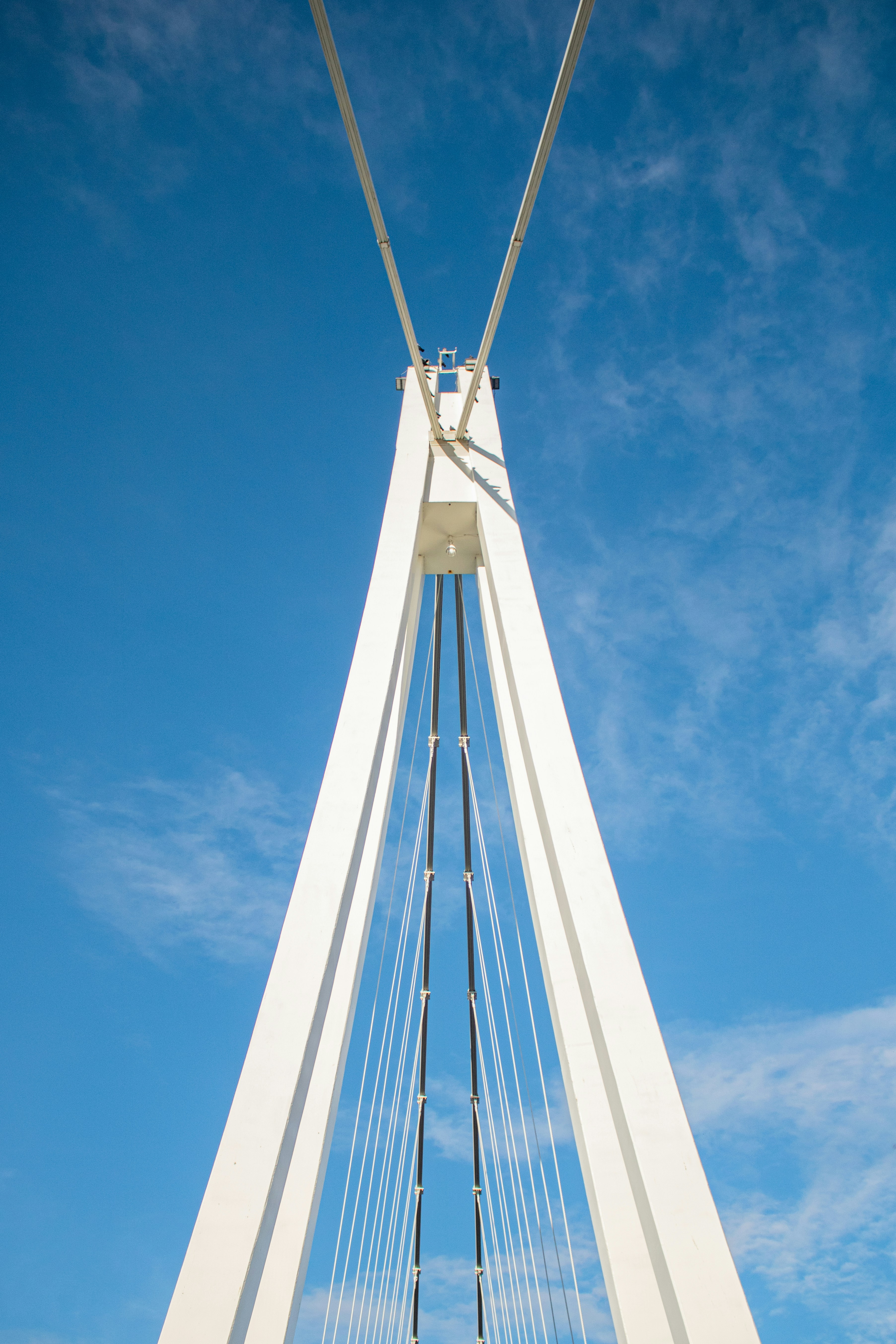 A tall white bridge with a sky background