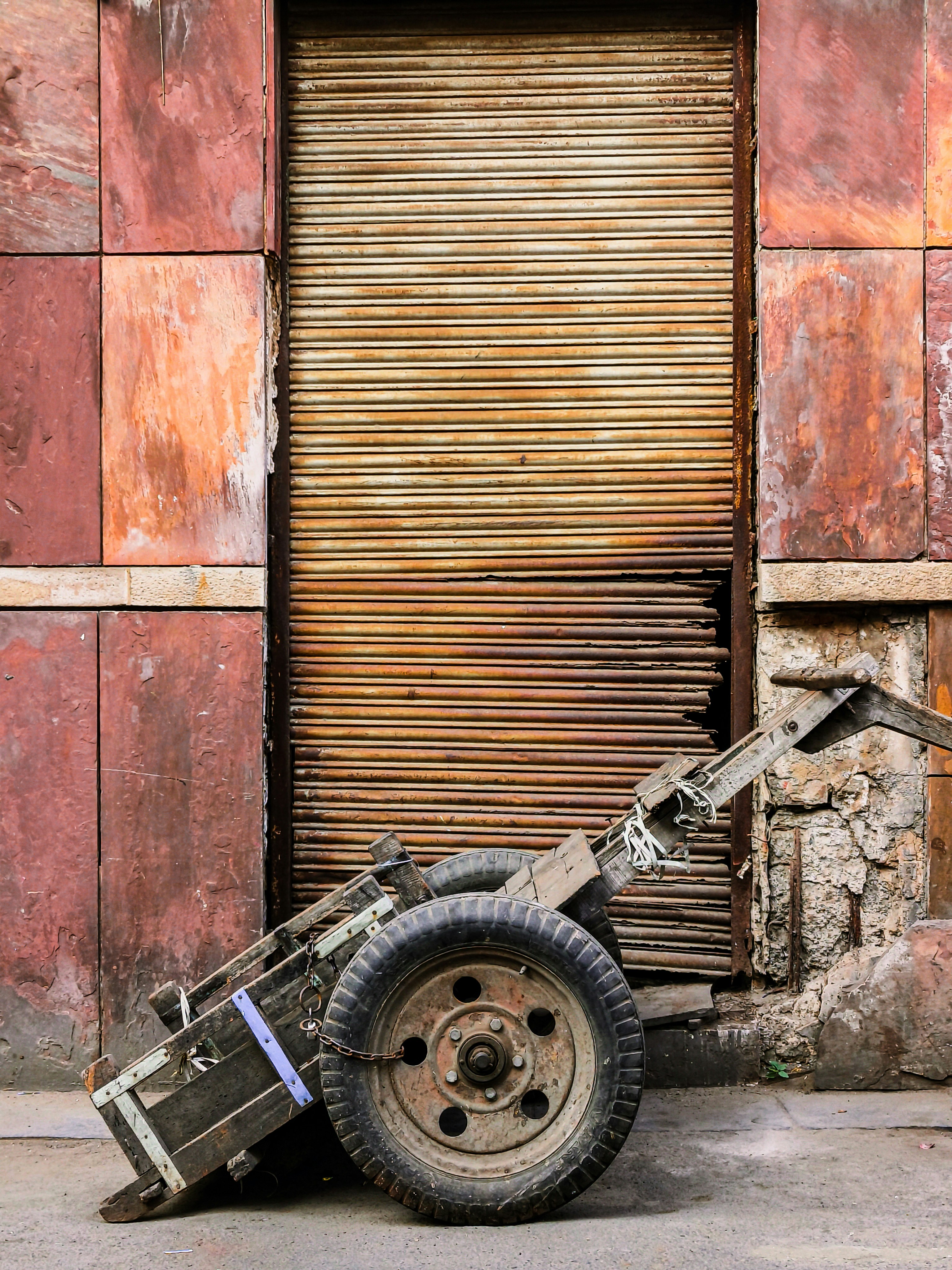 A wheelbarrow parked in front of a closed door