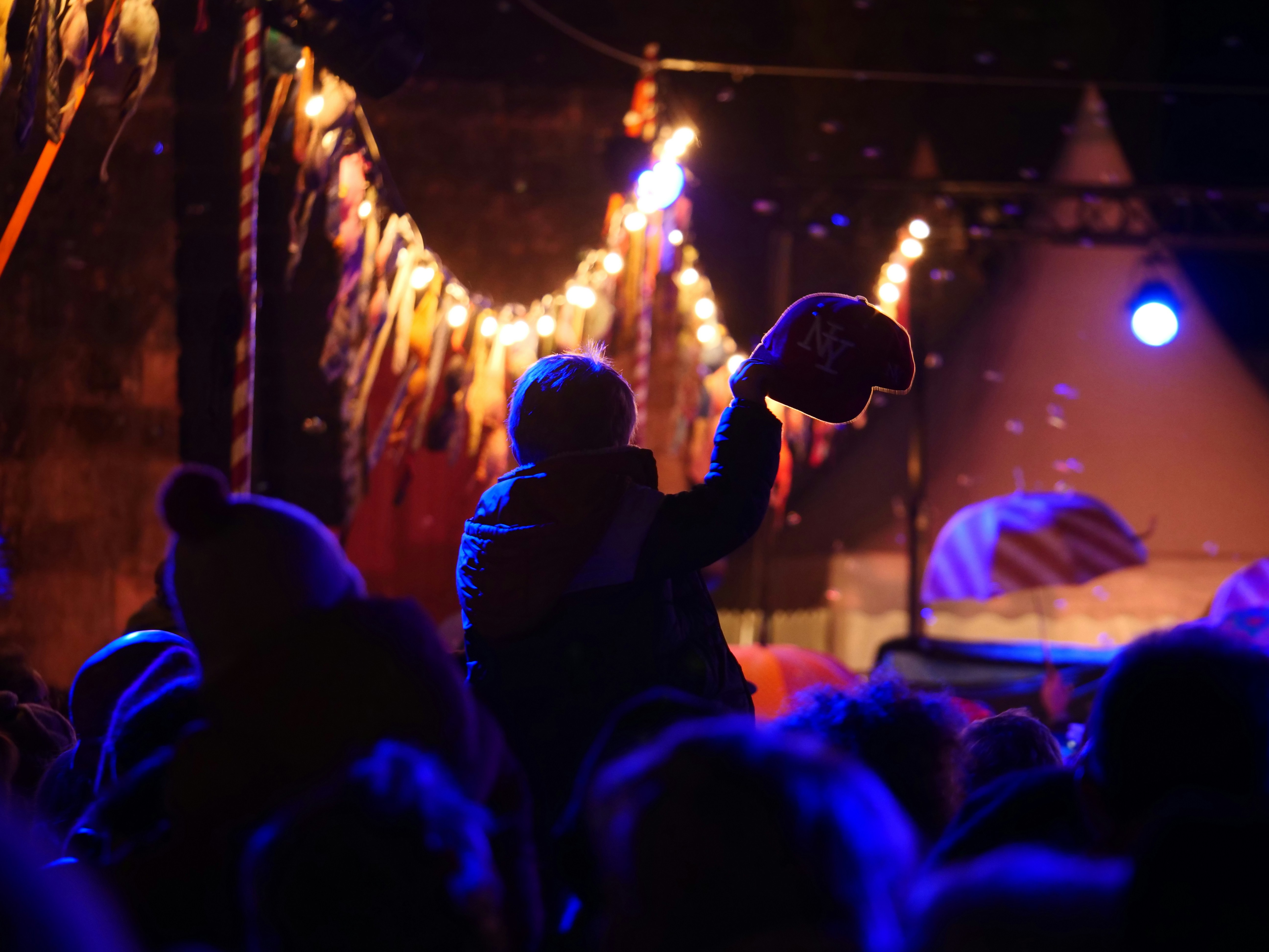 A man holding a basketball in front of a crowd