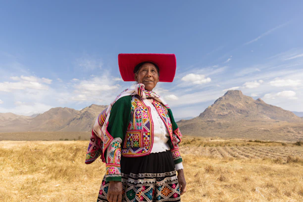 A woman with a red hat standing in a field