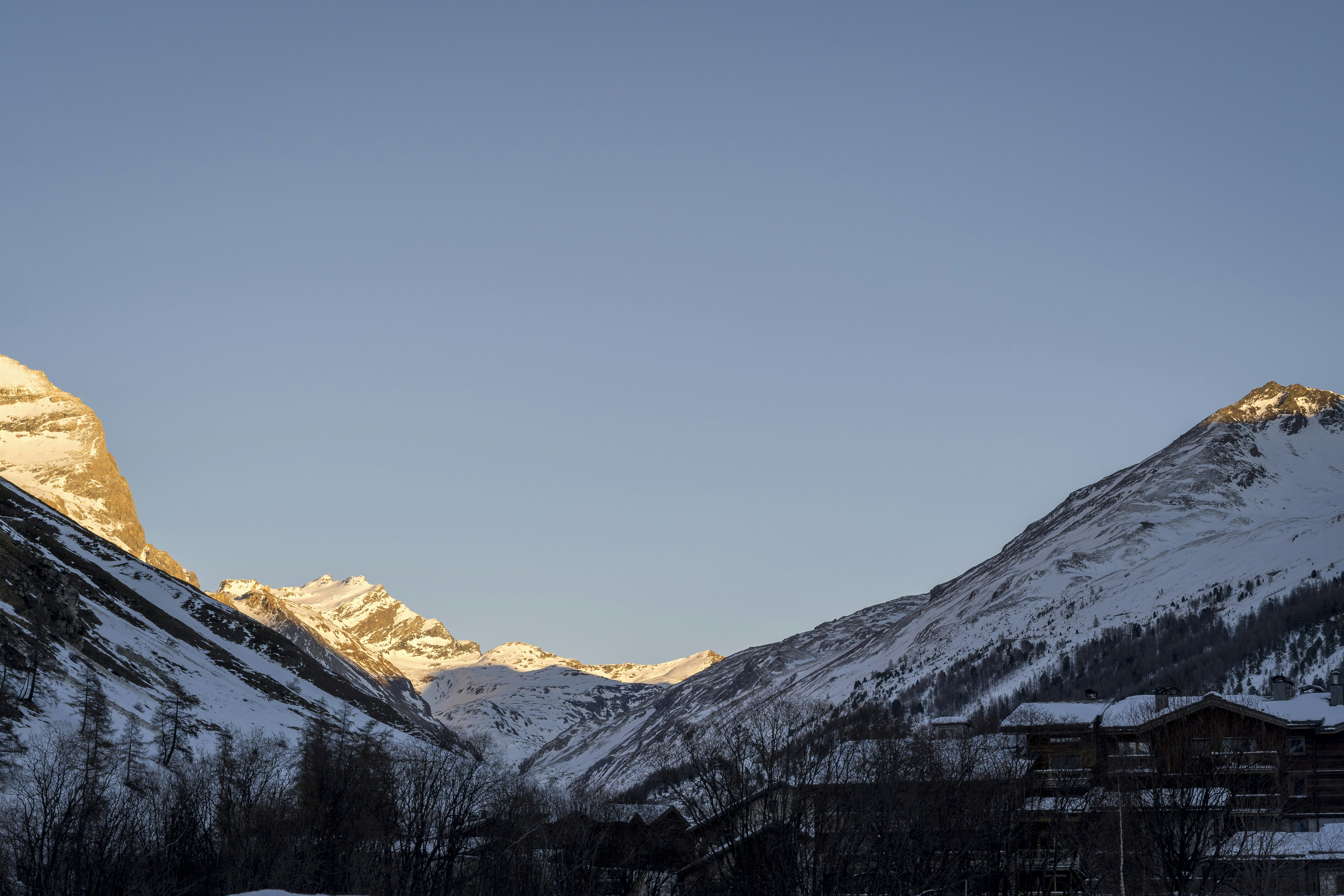 A snow covered mountain with a village in the foreground