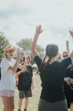 A group of people standing on top of a grass covered field