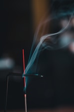 A smokestack with a red stick sticking out of it