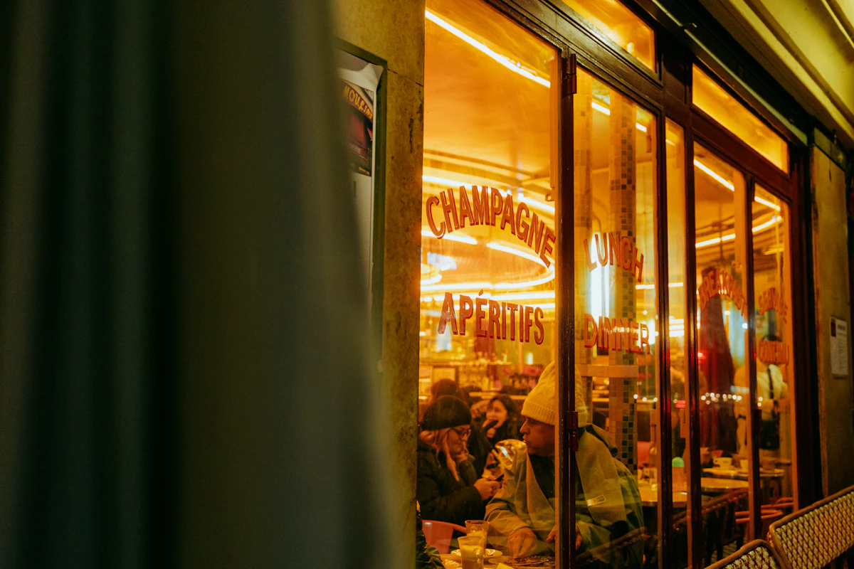 Champagne glasses on a polished bar in a softly lit lounge
