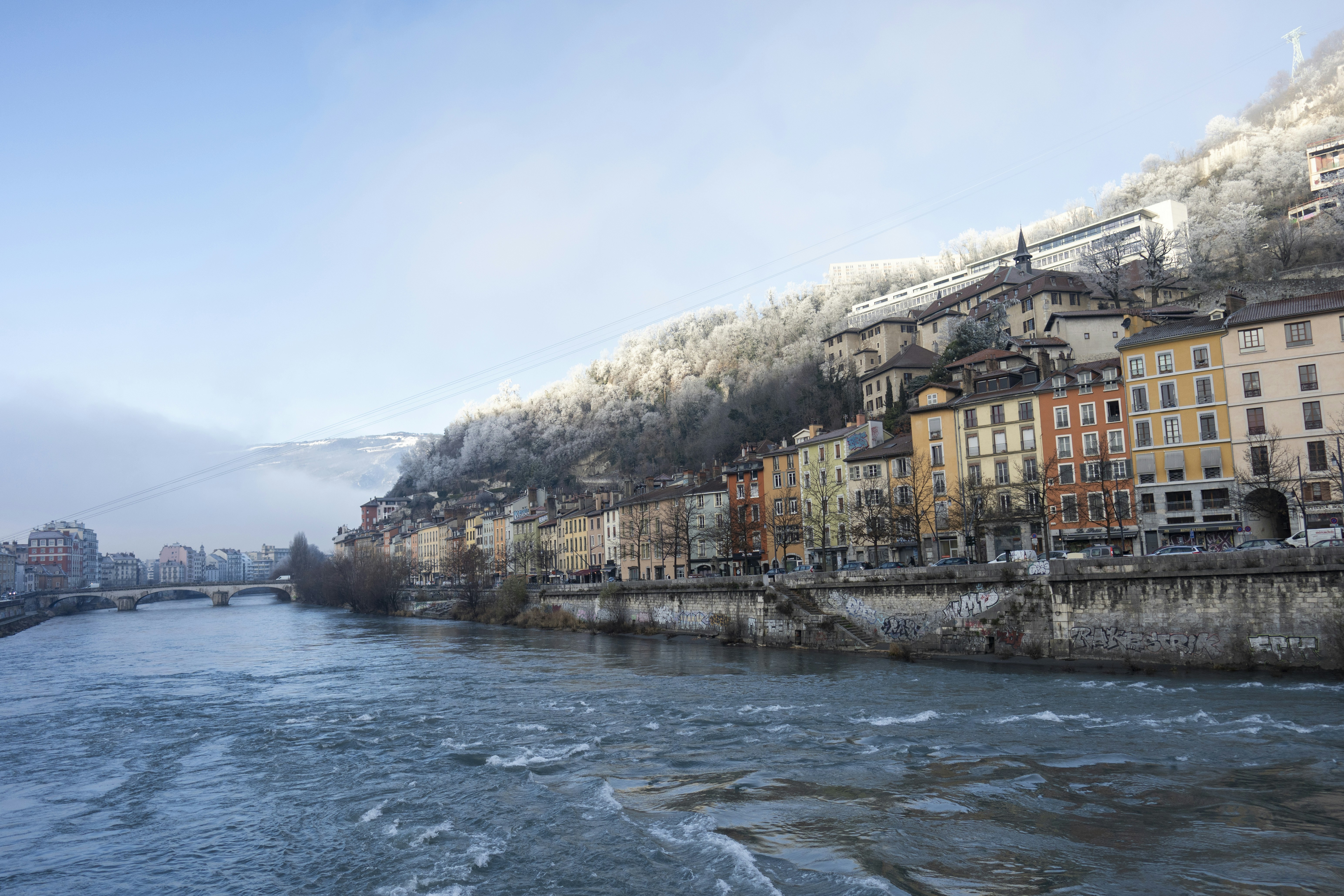 A river running through a city next to tall buildings