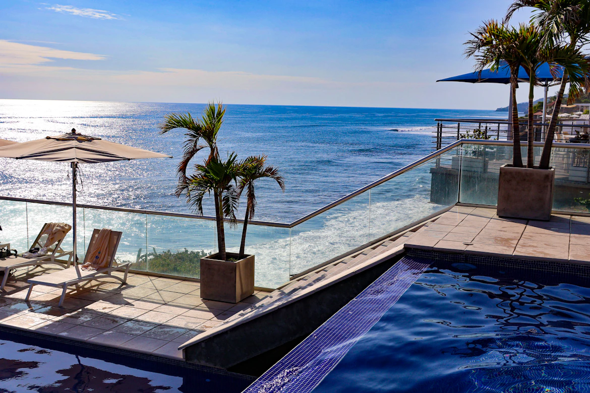 The tranquil pool and palms of a boutique coastal resort