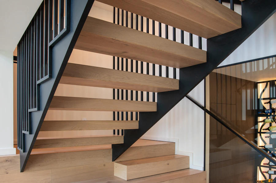 Warm contemporary wood staircase with black metal railings