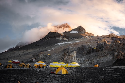 A group of tents set up on a mountain