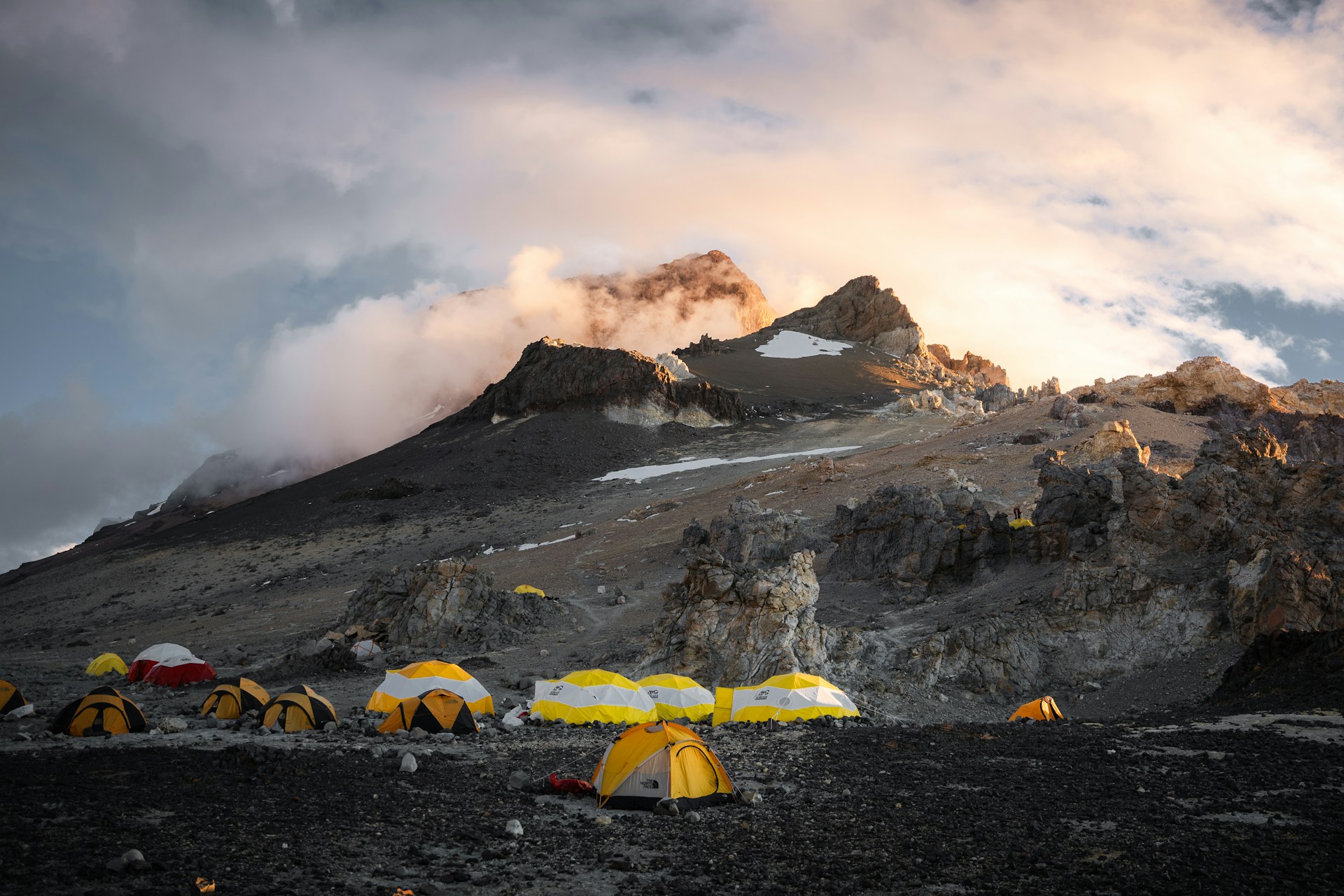 A group of tents set up on a mountain