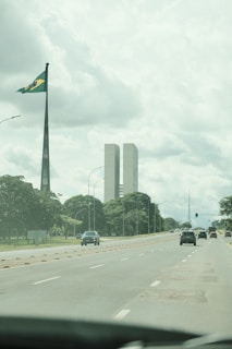 A car driving down a street next to tall buildings