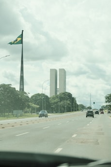 A car driving down a street next to tall buildings