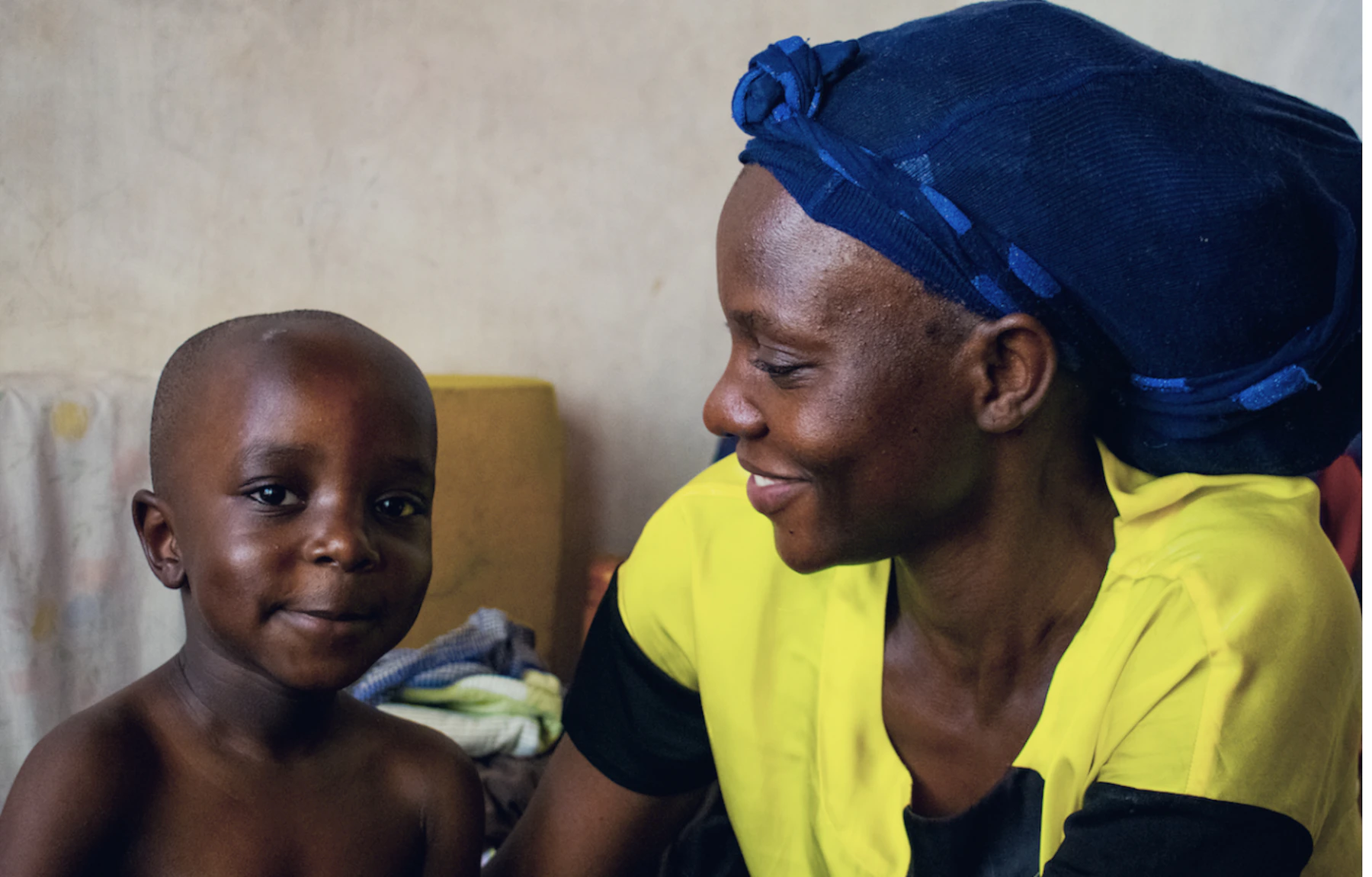 Mother and child sitting together inside their home