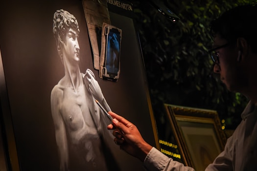 A man standing next to a statue of a man