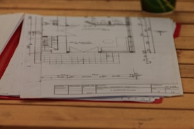A wooden table topped with lots of papers