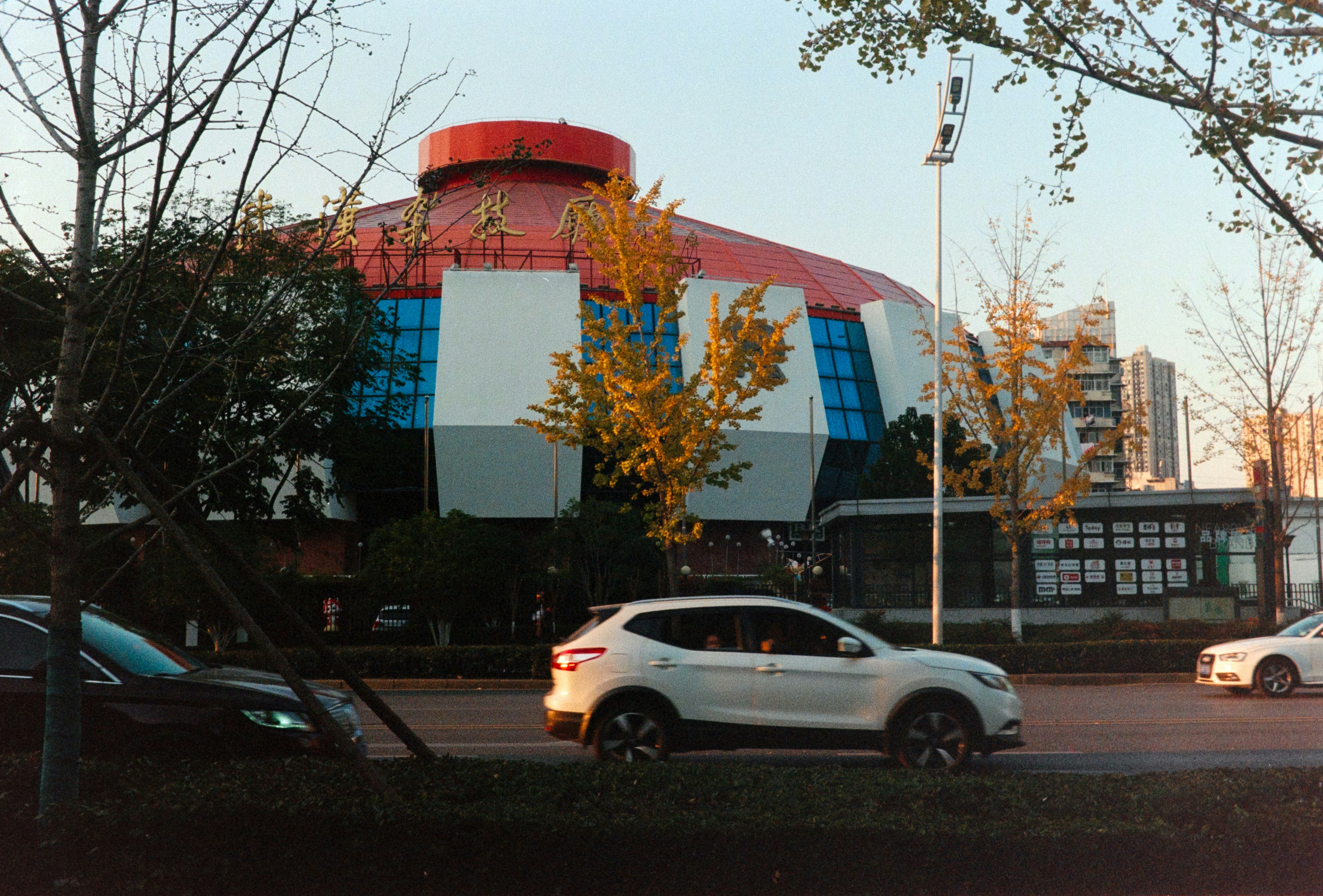 A white car parked in front of a building