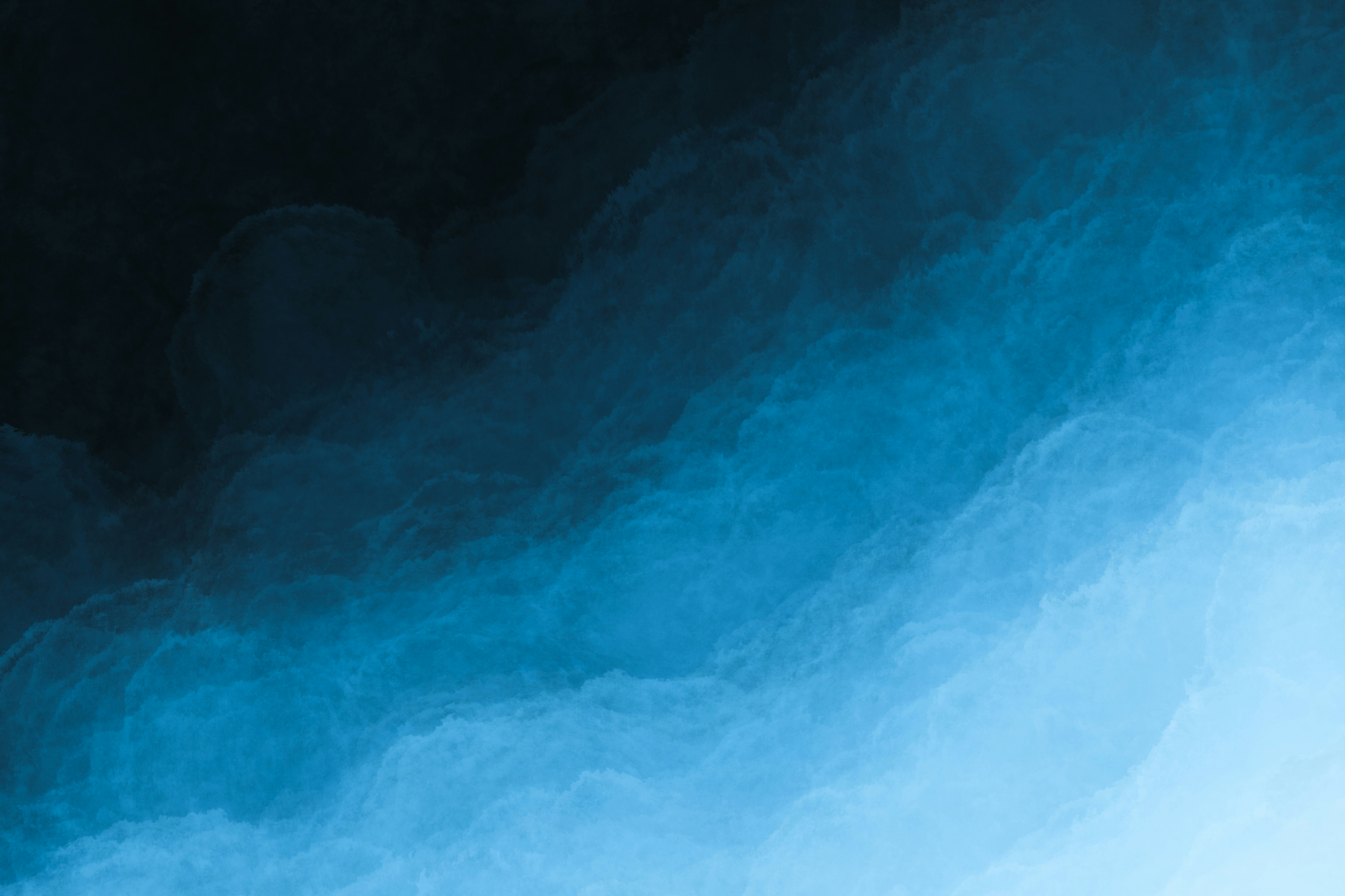 A blue and black background with some white clouds